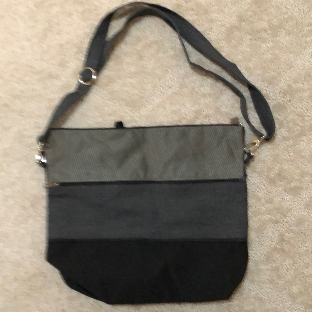 Jak’s fabric crossbody. Zip close. Front black, grey, pewter; back black.